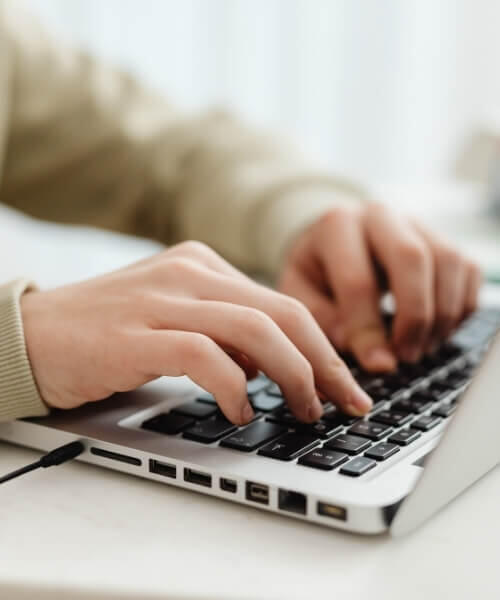 Corporate Wellness & Productivity hands typing at a keyboard